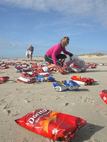 Local residents rush to pick up bags of chips from the beach