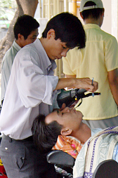 Getting a shave on the street in Nha Trang, Vietnam