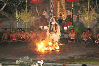 youth enters a trance and walks on fire at dance in bali