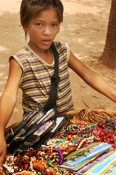 Child vendor with basket in Cambodia