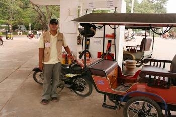 Motorcycle driven tuk-tuks carry tourists from Siem Realp to Angkor Wat ruins