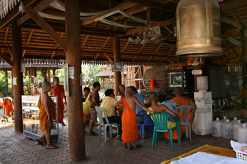 Young monks at Wat Lokmolee in Chiang Mai Thailand begin their novice work, a combination of studying, physical labor, and, occasionally, gathering to watch the one TV in the open air pavilion