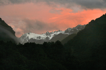 Sunset over mountains and river in Franz Josef New Zealand
