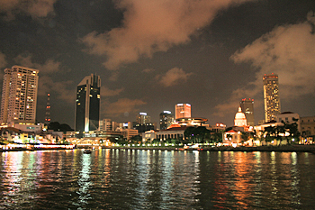 Lights of Singapore at night reflect on the river