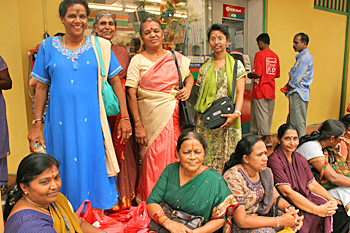 Women waiting for a bus in the Little India neighborhood of Singapore