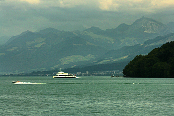 Alps emerge from the clouds on the as the ferry nears the southern end of Lake Zurich Switzerland