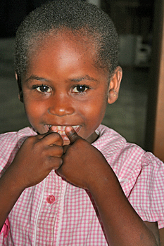 Adorable young girl from Zanzibar smiles shyly