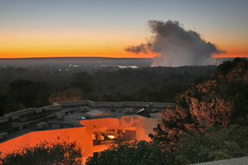 Mist of Victoria Falls from the roof of the hotel at sunrise in Zimbabwe