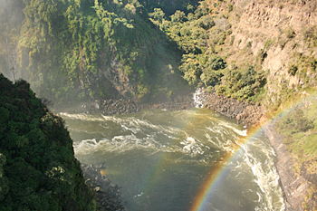 Rainbow over Victoria Falls Gorge from the bridge between Zimbabwe and Zambia