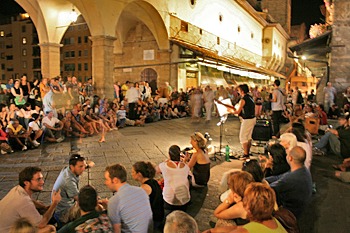 Musicians entertain on the Ponte Vecchio at night in Florence Italy