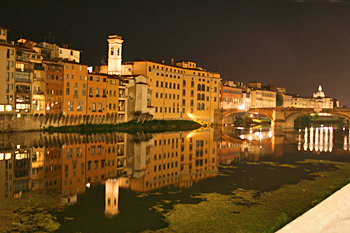 Buildings of Florence reflected in the Arno River at night