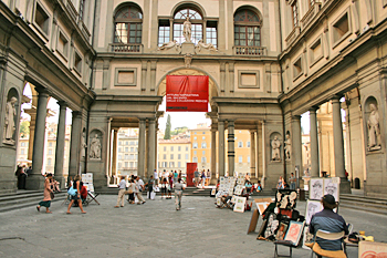 Street artists, selling their works from easel displays in Florence Italy