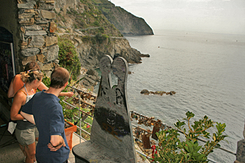 Tossing a padlock and key into the ocean to signfy love forever along "Via del Amore," between Riomaggiore and Manarola