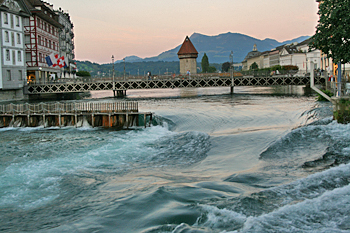 Sun sets over rapids on the Reuss River in Lucerne Switzerland