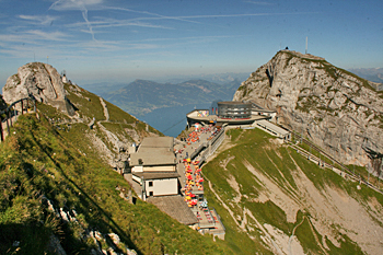 View from pinnacle of Mount Pilatus Switzerland looking down on the cog railway and gondola station