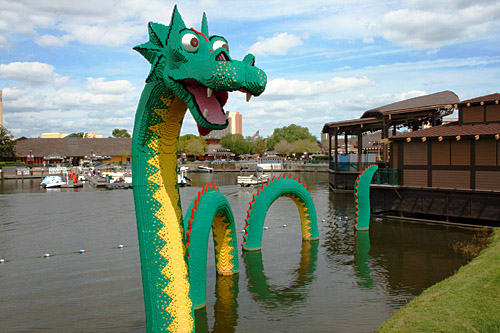 A sea monster made entirely from Legos emerges from the lake at the Marketplace in Downtown Disney