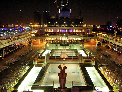 The pool deck on Celebrity Century at night, one of the many things you could enjoy on the cheap during a repositioning cruise