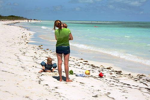 A young mother contemplates the loveliness of Sandspur Beach at Bahia Honda State Park