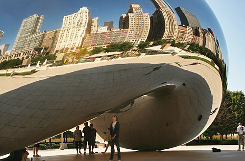 Closeup of Cloud Gate, with Chicago's skyline reflected in its polished surface