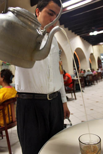 Pouring a lechero (espresso and steamed milk) at the Gran Cafe del Portal in the Zocaloof Veracruz