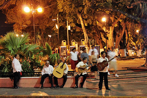 Trovas - roaming musicians who play romantic Yucatecan ballads - take a break on the Zocalo in Merida