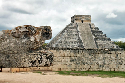 Serpent protruding from ball court stadium at Chichen Itza appears to devour Kukulcan pyramid
