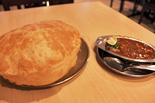 Batura (big fluffy bread) with chickpea stew at a vegetarian Indian restaurant, about $1 US