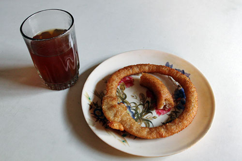 Tea and Selroti, fried rings made of rice flour