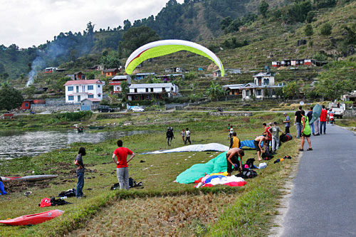 Paragliders take off from top of Sarangkot and land on the shores of Phewa Lake Pokhara Nepal