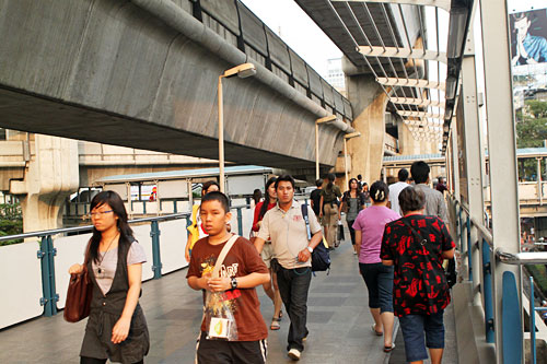 Pedestrians on the Sky Train (BTS) elevated walkway at Bangkok's Siam Square