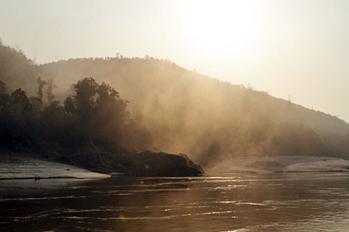 Mists rise from Mekong River at dawn during my Mekong River Cruise