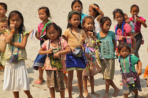 Hmong hill tribe children gather on shore to meet our boat