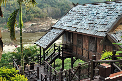 Individual teak and palm thatch cottage at Luang Say Lodge in Pakbeng, our overnight accommodations on the Luang Say Cruise