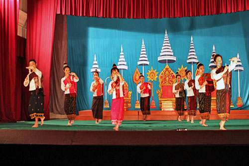 Beautiful Lao women perform perfectly syncopated dance steps