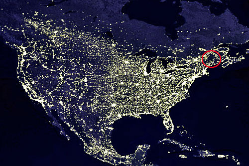 Night satellite image of the US, showing the dark area of Adirondack Park. Image courtesy of NASA/GSFC/Craig Mayhew and Robert Simmon