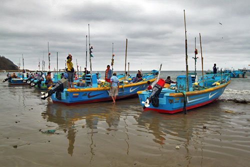 Fishing boats ready to launch in Puerto Lopez as tide comes in