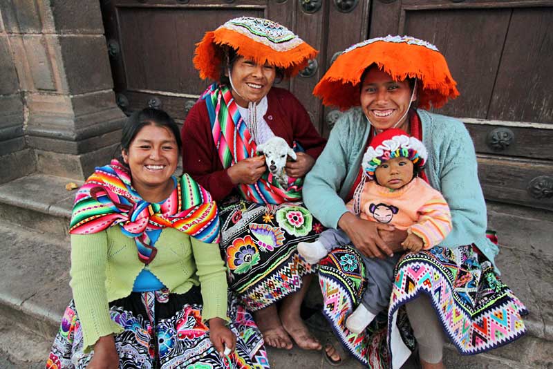 Indigenous Quichua Family Poses for Photo on Steps of a Church in Cusco, Peru