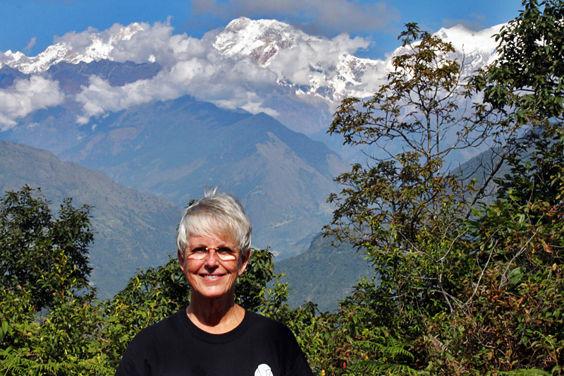 Barbara Weibel in Nepal, with the Annapurna Himalayas in the background