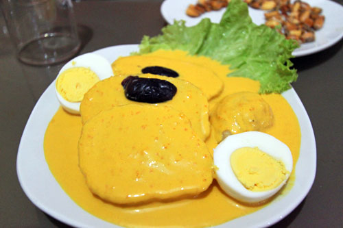 Papas a la Huancaina, Huancayo-style potatoes sliced and boiled, with a slightly spicy cheese sauce, topped with olives