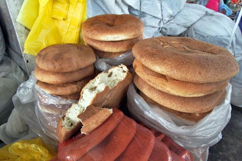 Huge rounds of whole wheat bread at the San Pedro Market in Cusco, Peru