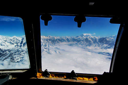 Mt. Everest in the distance, at right, from the cockpit window
