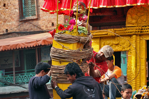 Tying the idol of the god Bhairav onto the prow of the giant wooden chariot