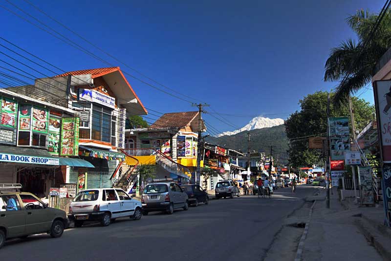 Annapurna Himalayas peek over the main street of Pokhara, Nepal