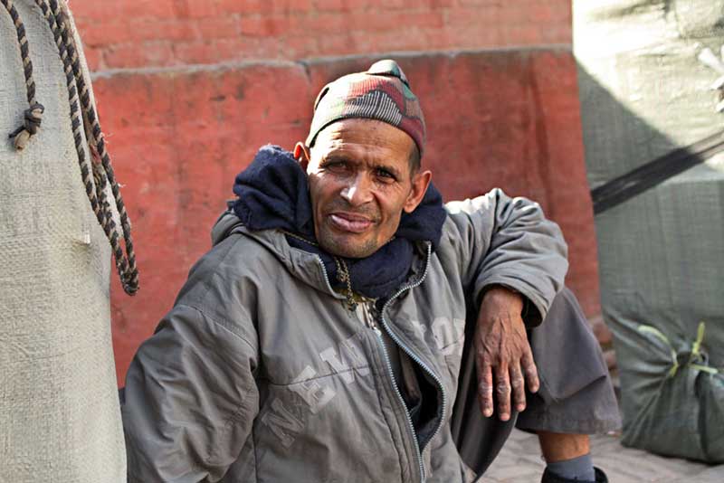 Porter Takes a Rest From Carrying His Heavy Load in Durbar Square, Kathmandu, Nepal
