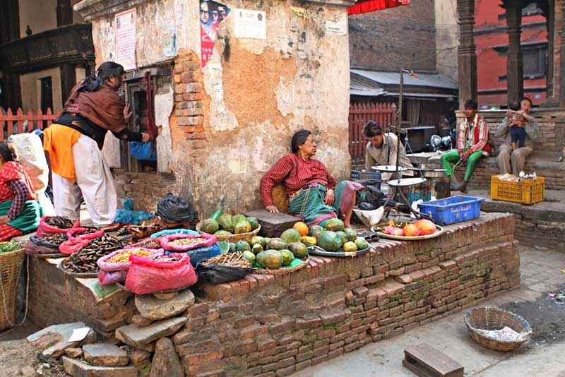 Vegetable Seller Displays Her Wares Around an Old Building in Kathmandu, Nepal 