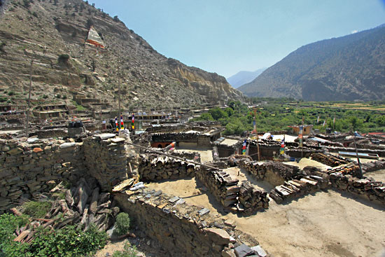 Looking down on flat rooftops of Marpha, edged with piles of firewood