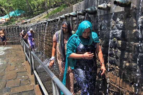 Devotees walk or run through the 108 holy fountains at Muktinath