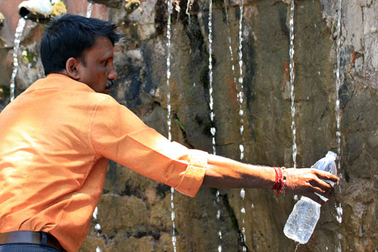 Taking home water from the 108 holy fountains at Muktinath