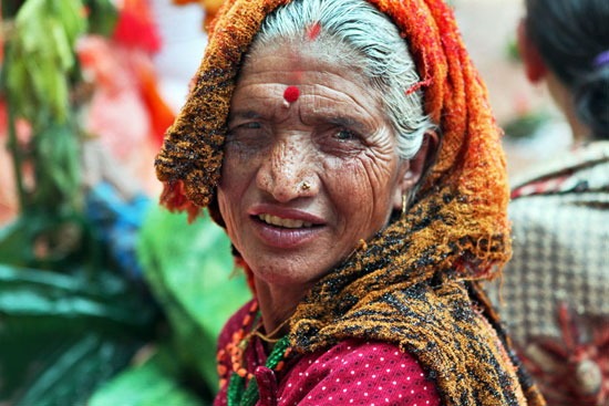 Woman attending a puja to honor a deceased relative in Nepal