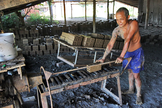 Making bricks from local clay near Bamboo Train line, Battambang, Cambodia